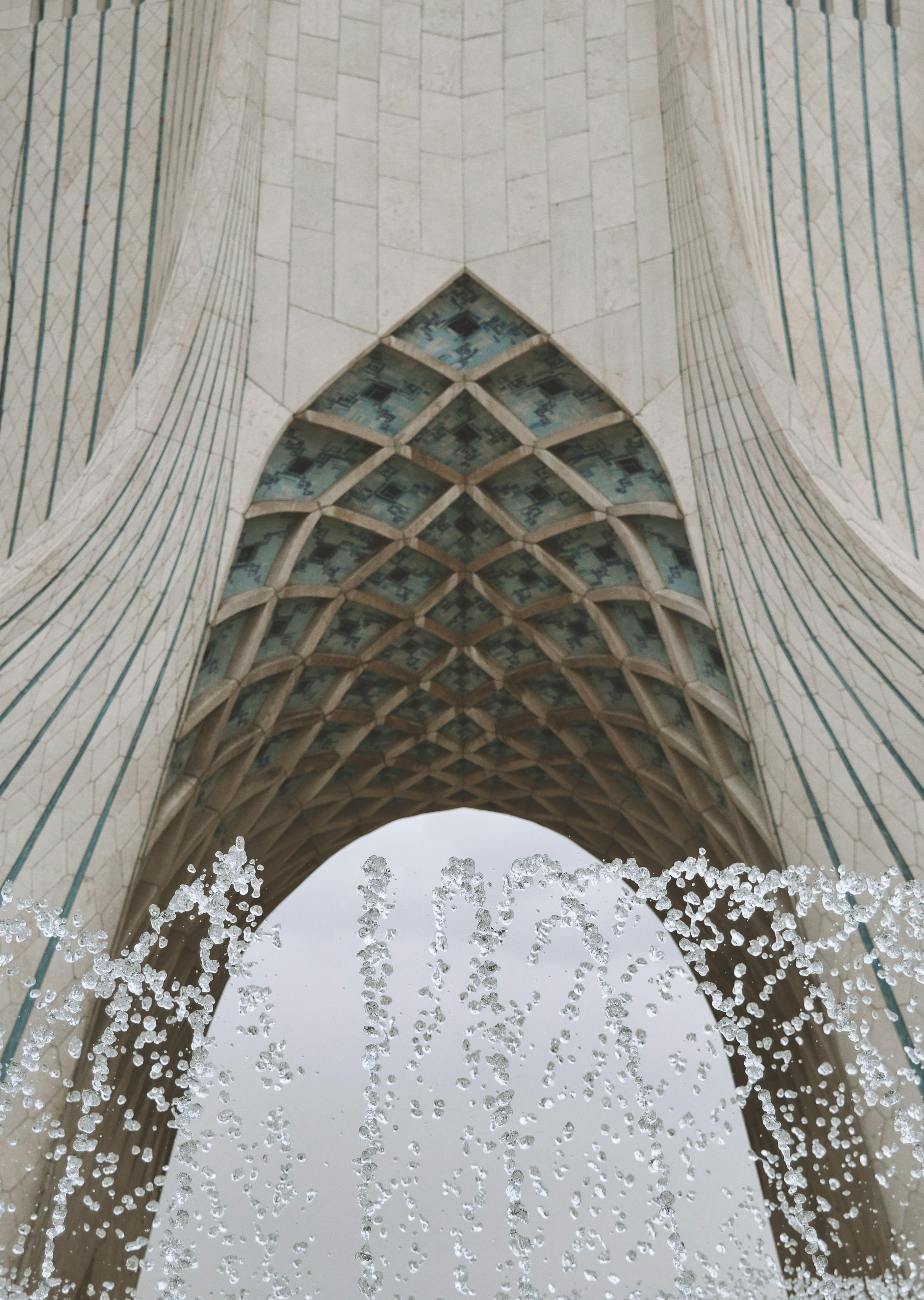 water fountain in the middle of gray concrete building